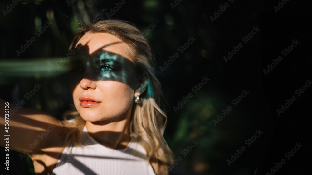Portrait of a beautiful young blonde woman with blue eyes with blue reflection on face skin. Portrait of a beautiful young blonde woman with blue eyes with blue reflection on face skin.