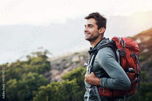 Man, backpack and thinking in nature forest for wilderness experience, exploration and solitude for stress relief or mental health. Guy, outdoor and hiking in woods for adventure or physical exercise