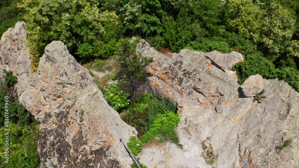 The Deaf Stones - Gluhite Kamani Rock Sanctuary With Foliage In Rhodope Mountains, Bulgaria. ascending drone shot The Deaf Stones - Gluhite Kamani Rock Sanctuary With Foliage In Rhodope Mountains, Bulgaria. ascending drone shot