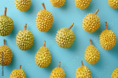 A bunch of yellow and green fruit with a blue background