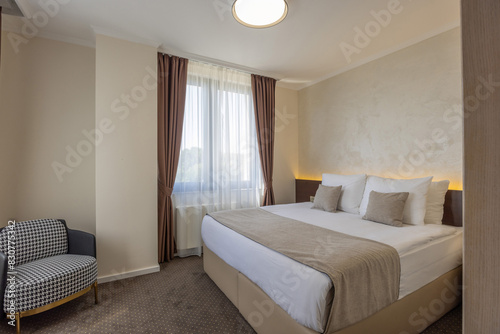 Interior of a beige brown hotel bedroom © rilueda