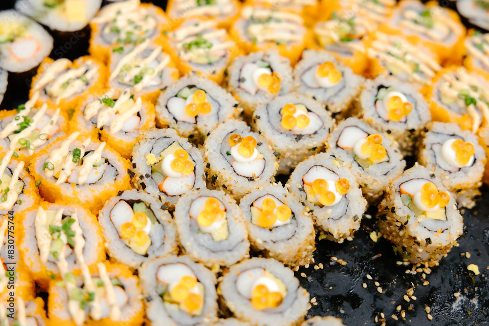 Maki sushi with shrimp eggs, buffet style, ready to be served to guests at the event. Maki sushi with shrimp eggs, buffet style, ready to be served to guests at the event.