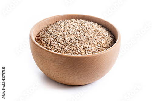 sesame seeds in a wooden bowl isolated on white background