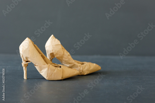 A brand new high heels shoes wrapped in rustic beige craft paper. Black Friday shopping concept.