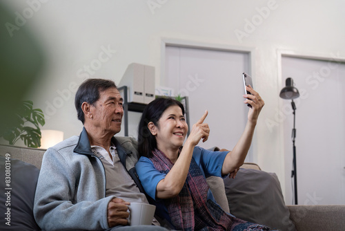 Senior couple taking selfie at home. Concept of technology, companionship, and relaxation
