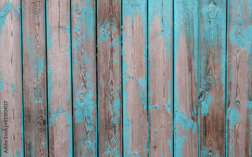 Fotografia Old wooden turquoise fence with scuffed turquoise
