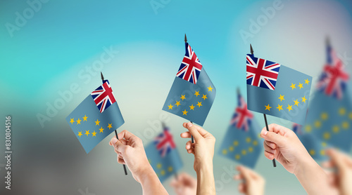 Fototapeta Naklejka Na Ścianę i Meble -  A group of people are holding small flags of Tuvalu in their hands.