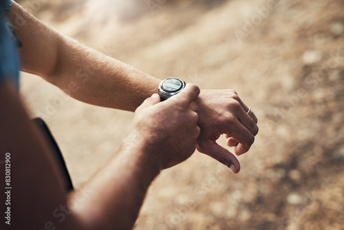 Hands  time and man hiking outdoor for cardio  exercise and wilderness experience or exploration. Male athlete  smart watch or stopwatch to track progress for adventure  wellness and check results.