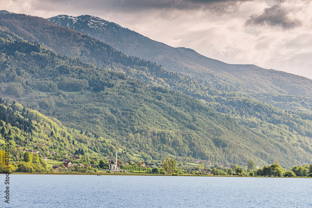 In Plav, Montenegro, a mosque overlooks the tranquil lake, blending into the scenic Balkan landscape with its traditional architecture. In Plav, Montenegro, a mosque overlooks the tranquil lake, blending into the scenic Balkan landscape with its traditional architecture.