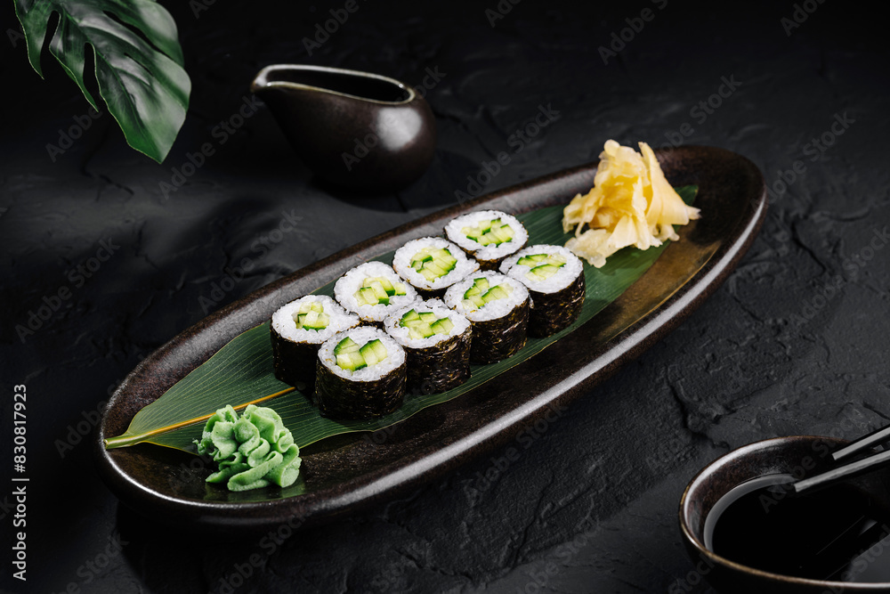 Elegant sushi platter presentation on dark background Elegant sushi platter presentation on dark background