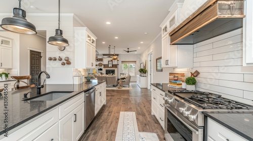 a fashionable kitchen  featuring pristine white surfaces  a sleek black countertop  and rich dark wood cabinets  illuminated by soft  warm natural light