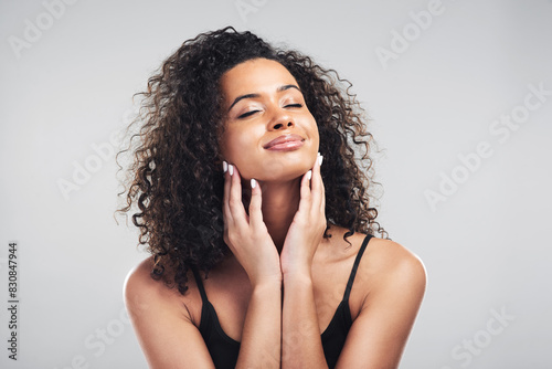 Portrait, woman and studio in relax for skincare, beauty and cosmetic on white background. Curly hair, cosmetology and facial treatment with collagen for model person, hands or texture for haircare