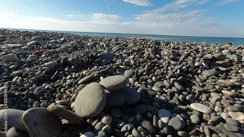 tower of flat stones fall over on rocky beach in Batumi Georgia