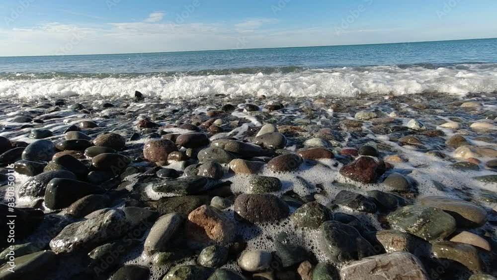 sea is visible, with gentle waves approaching the shore under a clear sky. very relaxing sea is visible, with gentle waves approaching the shore under a clear sky. very relaxing