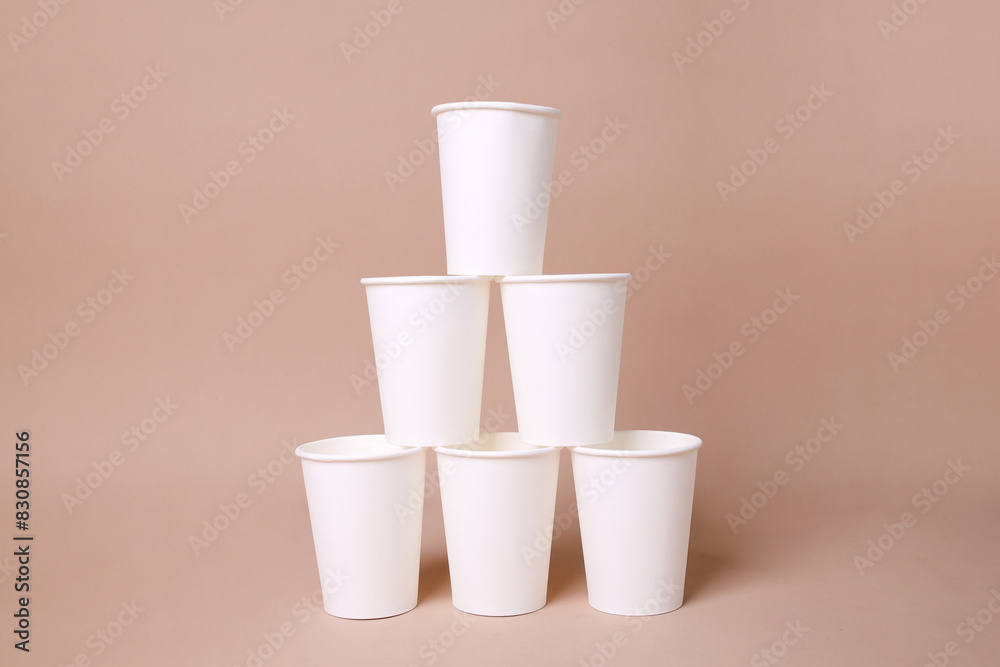 Creativity Of Blank White Cup Arrangement Isolated On Beige Background Creativity Of Blank White Cup Arrangement Isolated On Beige Background