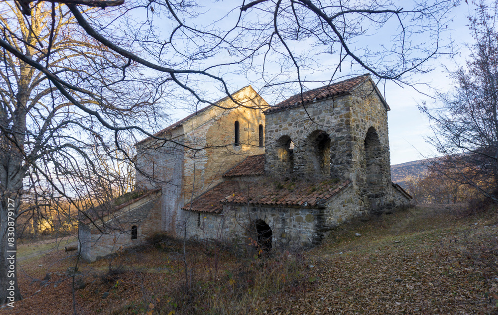 St. Shio's monastery complex and wine cellar. The evening sun illuminates the wall of the church St. Shio's monastery complex and wine cellar. The evening sun illuminates the wall of the church