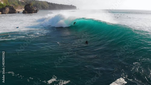 Drone view of surfing at barrel wave. Surfer riding on barrel wave. Swell in Bali