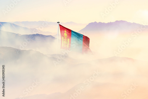 Mongolia flag disappears in beautiful clouds with fog.