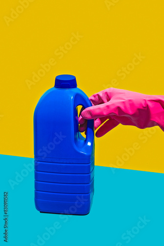 Hand with pink latex glove holding gallon