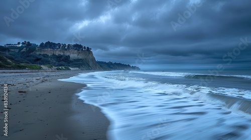 Waves hitting beach under cloudy sky, showing natures beauty and tranquility