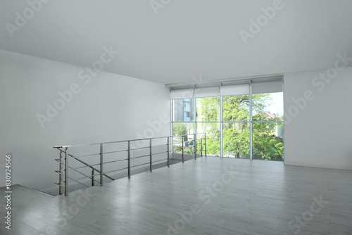 Large empty hall with windows and railings photo