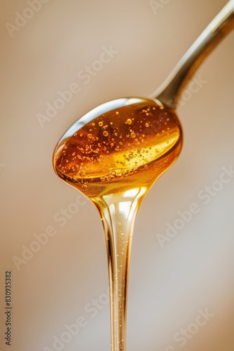 Thick flow on the spoon, delicious, pure thick crystal clear honey, pure picture, background beige light and shadow, professional photography, generated with AI