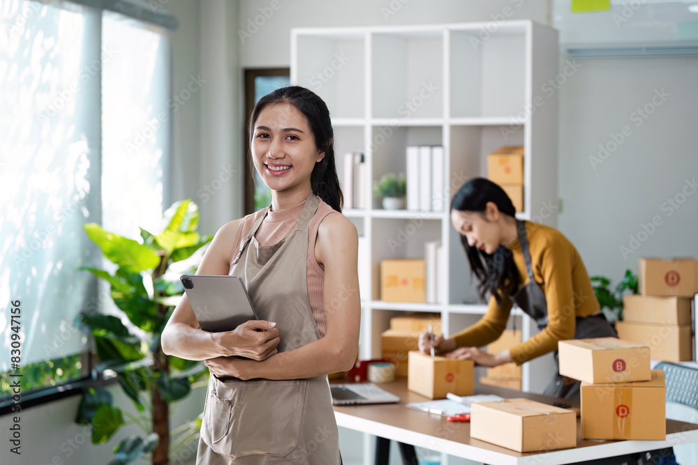 Entrepreneur startup business woman sme holding tablet. Small Online Business Owner, Online Marketing and Product Packing and Delivery Service. E-commerce concept Entrepreneur startup business woman sme holding tablet. Small Online Business Owner, Online Marketing and Product Packing and Delivery Service. E-commerce concept