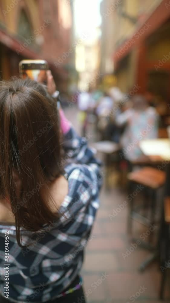 A lively young woman walks along the sunny avenues of Bologna.