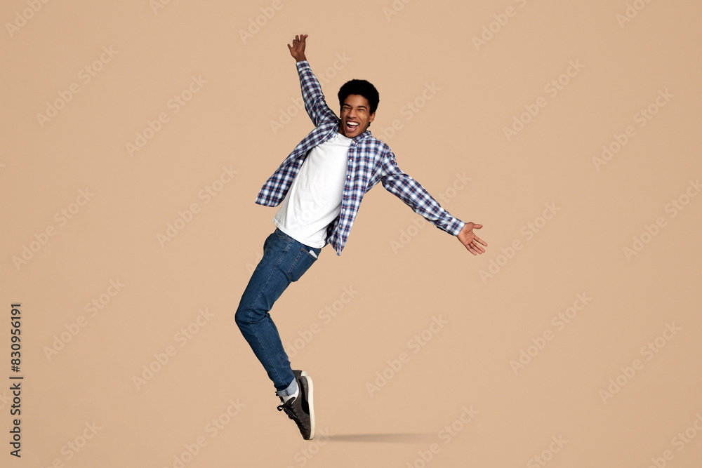 Funny Black Guy Fooling, Standing on Sneakers Toes on White Studio Background Funny Black Guy Fooling, Standing on Sneakers Toes on White Studio Background