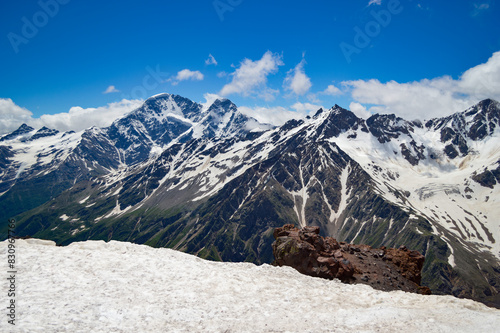 Beautiful peaks of the Western Caucasus on a sunny summer day. Mountains covered with snow and glaciers