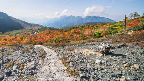 秋の那須岳（茶臼岳）　紅葉する「姥ヶ平」へ続く登山道【栃木県・那須塩原市】　
Mt. Nasu in autumn. A mountain trail leading to a plateau with autumn leaves - Tochigi, Japan photo