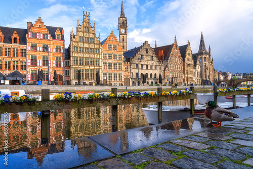 Scenic view of the historical city center of Ghent (Gent), Belgium. Beautiful cityscape with medieval architecture, monumental landmarks and Lys river with tourist boats, outdoor travel background