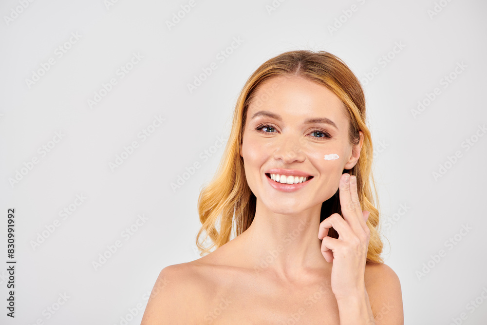 Young woman applying face cream during skincare routine. Young woman applying face cream during skincare routine.