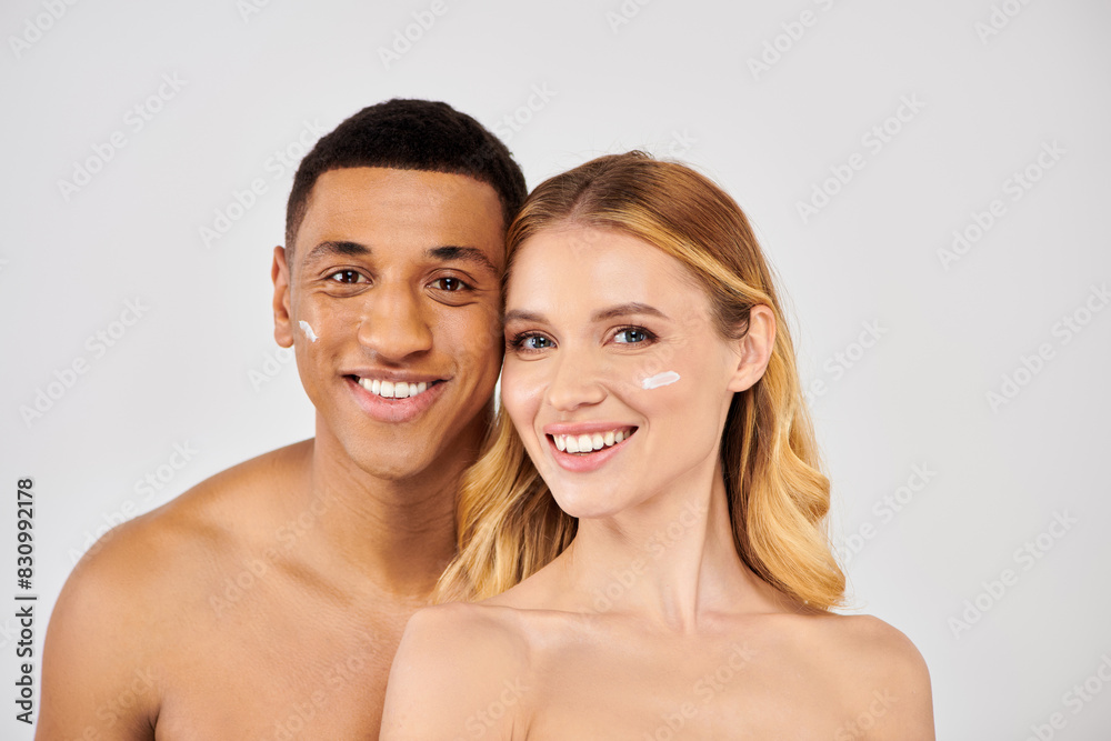Young man and woman pose affectionately during skincare routine. Young man and woman pose affectionately during skincare routine.