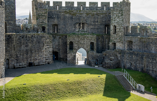 stones, walls and towers of Caernarfon Castle, a medieval fortress in Wales