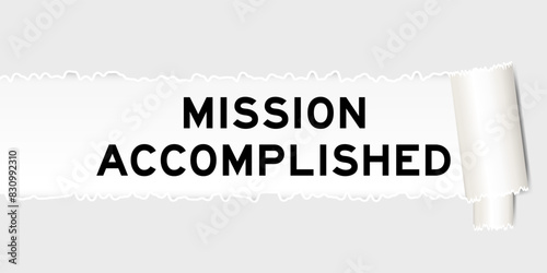 Ripped gray paper background that have word mission accomplished under torn part