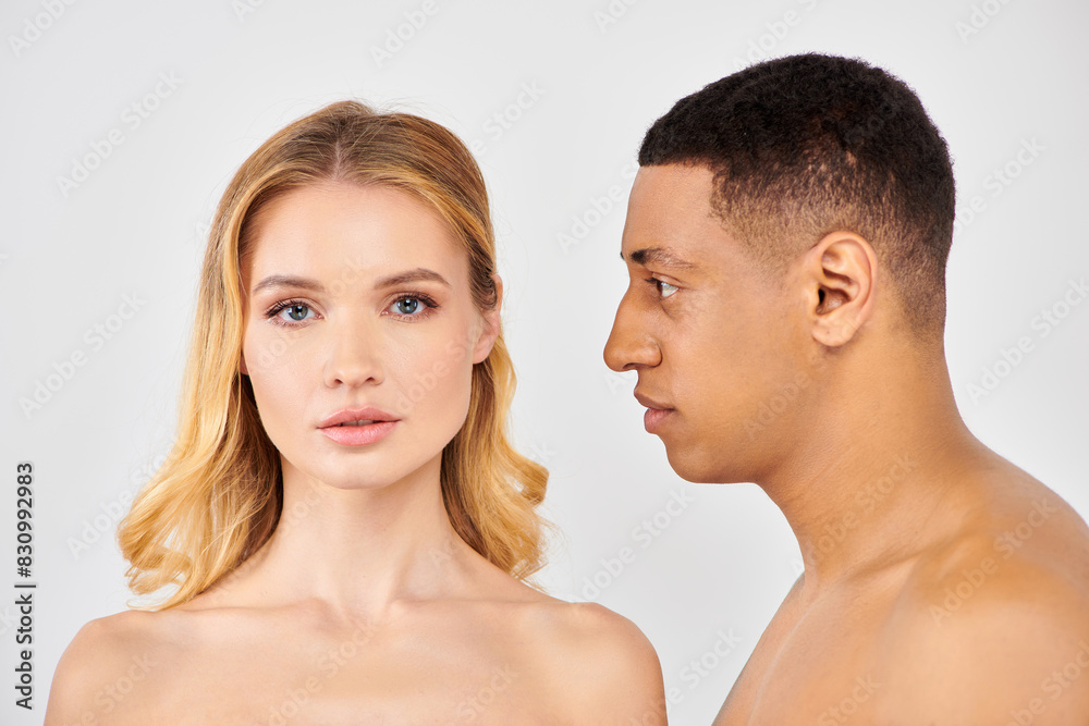 Trendy diverse couple sharing a moment, gazing lovingly at each other. Trendy diverse couple sharing a moment, gazing lovingly at each other.