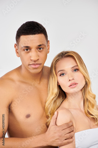 Attractive couple posing lovingly for a portrait.