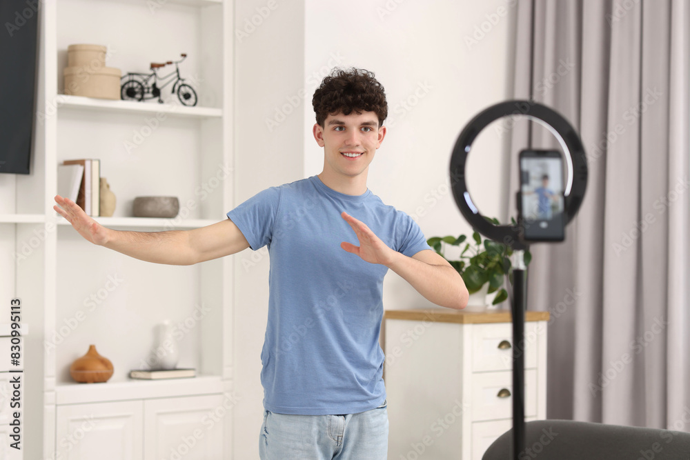 Smiling teenage blogger explaining something while streaming at home Smiling teenage blogger explaining something while streaming at home
