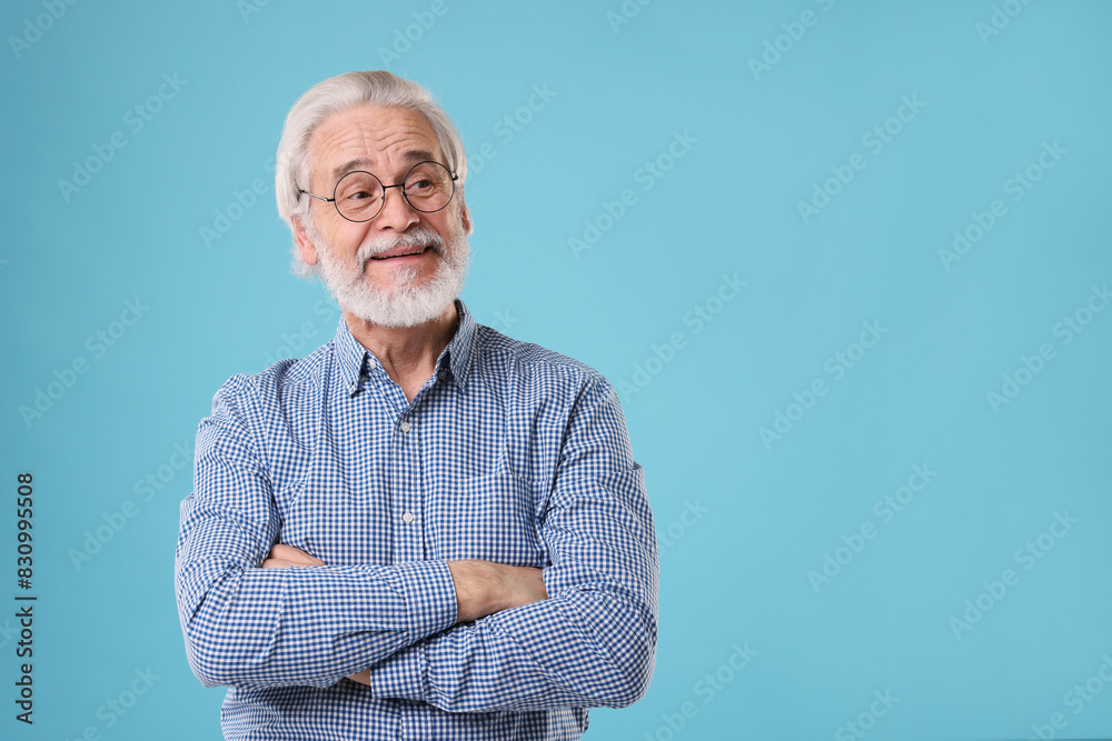 Portrait of stylish grandpa with glasses on light blue background, space for text Portrait of stylish grandpa with glasses on light blue background, space for text