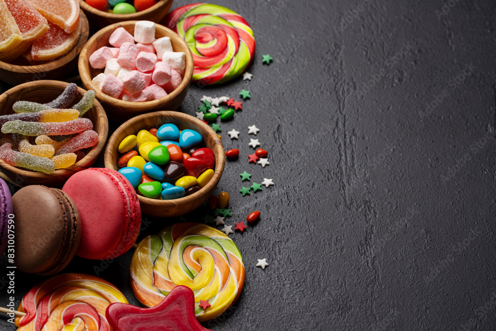 Various colorful candies, lollipops, and macaroons