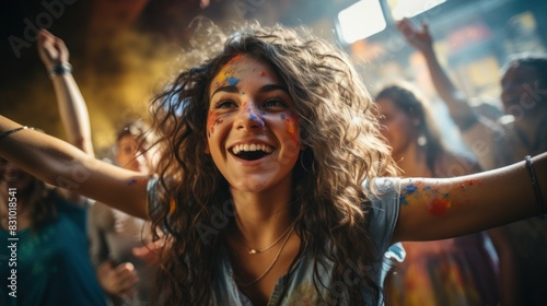 The sheer jubilation of a festival comes alive as a young woman celebrates with colorful paint