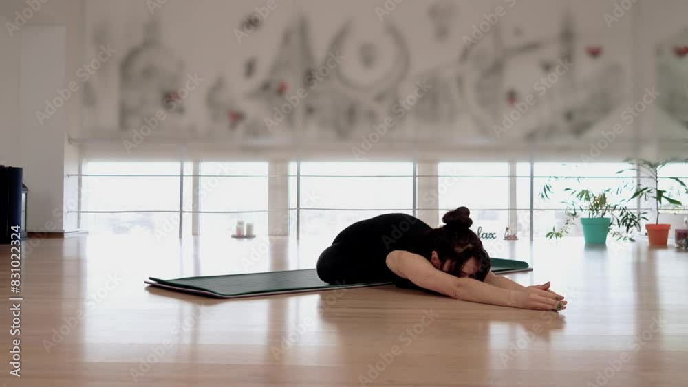 Athletic asian woman practice yoga stretching pose for muscle training and warm up with meditation. Fitness mat in gym room, healthcare and exercise mental therapy concept