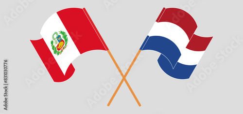 Crossed and waving flags of Peru and the Netherlands