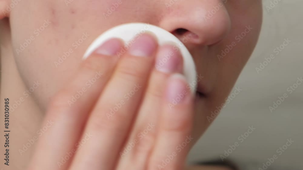 A woman uses a facial wipe for skincare in a closeup shot, aiming for a fresh and clean complexion A woman uses a facial wipe for skincare in a closeup shot, aiming for a fresh and clean complexion