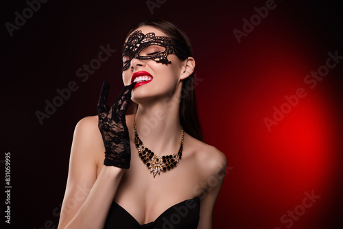 Photo of lady in black carnival costume dress bite teeth gloves feel passionate isolated red color background
