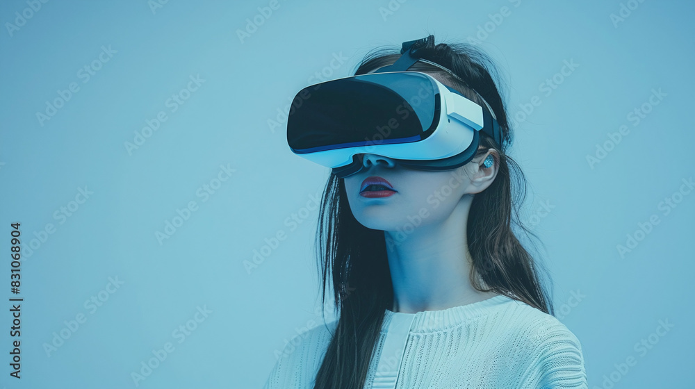 Woman wearing Virtual Reality headset exploring immersive technology isolated on blue background Woman wearing Virtual Reality headset exploring immersive technology isolated on blue background