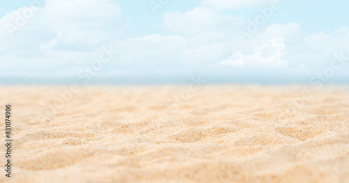 Sea Beach Sand with blurry sky blue cloud Background Summer beach with wave sand blurred blue ocean water.Nature landscape of beautiful tropical seaside in sunny day.Vacation Travel Holiday concept