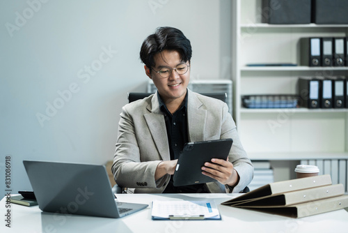 Businessman sitting at his desk in the office, success at work in the office concept.