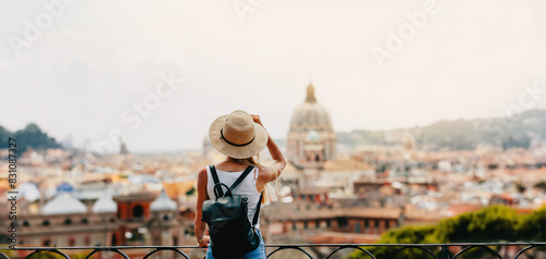 Young attractive smiling girl tourist exploring new city at summer